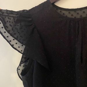 Black blouse with polka dots, ruffles, and sheer panels